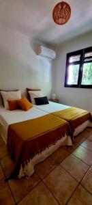 a bedroom with a large bed in a room at Bungalow et Duplex de Island Bay in Bouillante