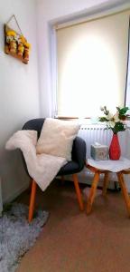 a living room with a chair and a table at Ferienwohnung an der Dhron in Neumagen-Dhron
