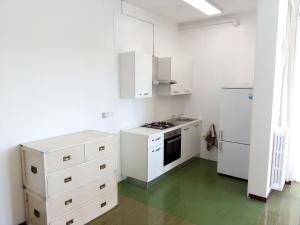 a kitchen with white cabinets and a green floor at Le Dimore di Otranto - Altomare in Otranto
