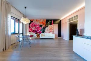 a living room with a table and a painting on the wall at La Bella Vita - Maison Dina in Chioggia
