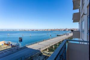 a large body of water with a pier next to a building at La Bella Vita - Maison Dina in Chioggia