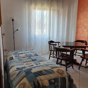 a bedroom with a bed and a table and chairs at Casa Magnolia in Arena Metato