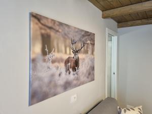 a large painting of a deer on a wall at Moda Apartments 01 in Sestriere