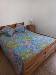 ein Bett mit einer Decke und Kissen in einem Schlafzimmer in der Unterkunft La Casa de Pichona in Miramar