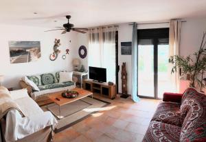 a living room with a couch and a tv at Casa Indalo - Resort Macenas Mojacar in Mojácar