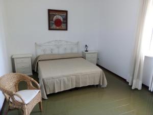 a bedroom with a bed and two dressers and a chair at Le Dimore di Otranto - Altomare in Otranto
