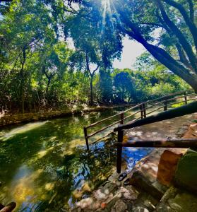 uma ponte sobre um rio com o sol brilhando em IMG Hotel Rio Quente em Rio Quente