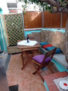 a table and a chair on a patio at exclusive house sardinia in Cala Gonone