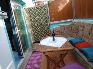 a table with a bottle of wine sitting on a patio at exclusive house sardinia in Cala Gonone