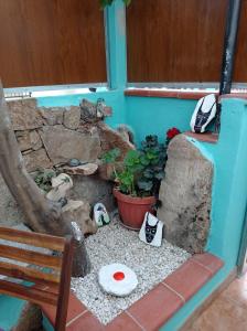 a miniature garden with a bench and a rock wall at exclusive house sardinia in Cala Gonone