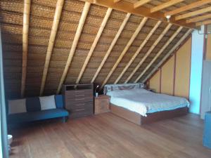 a bedroom with a bed and a chair in a room at La Casa del Naufrago in Lobitos