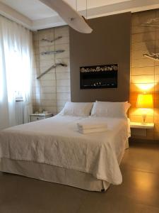 a bedroom with a large bed with a white bedspread at ZEROstuni suite apartment in Ostuni