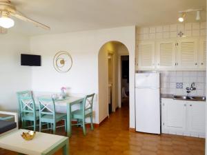 eine Küche und ein Esszimmer mit einem Tisch und einem Kühlschrank in der Unterkunft Cheap & Chic Apartamentos en Son Bou de 2 dormitorios in Son Bou
