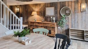 a dining room with a table and chairs at The Threshing Barn at Penrhos Court in Kington