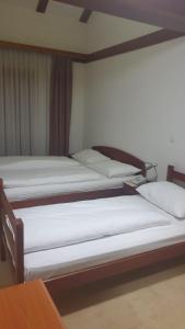 two twin beds in a room with at Hotel Knez in Kupres