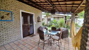 a patio with a table and chairs on a patio at Chalé 17 - Porto do Sol - Pipa in Pipa