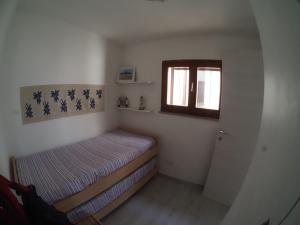 מיטה או מיטות בחדר ב-Perla del mare