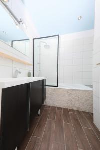 a bathroom with a large sink and a tub at Duplex atypique proche gare & centre ville in Mulhouse