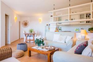 a living room with a white couch and a table at Villa Marysol in Chia