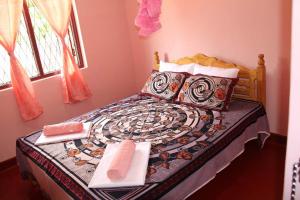 a bedroom with a bed with two towels on it at Batti Relax Point in Batticaloa