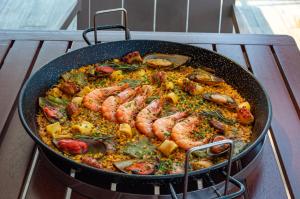 a pan with shrimp and other food in it at Arena Ipanema Hotel in Rio de Janeiro