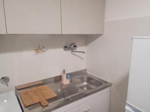 a small kitchen with a sink and a counter at Sea view in Lerici
