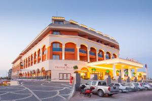 a large building with cars parked in front of it at Orange Palace Side - All Inclusive in Side