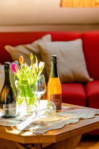 two bottles of wine and a glass on a table at Hoefer der Genusstreffpunkt in Am Waldgrund