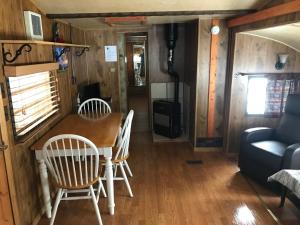 a dining room and living room in a tiny house at Grandview Cabins & RV Resort in South Fork