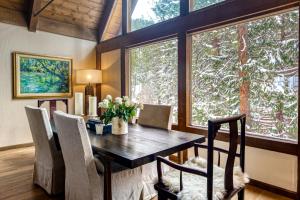 a dining room with a table and chairs and windows at The Chalet in Zephyr Cove