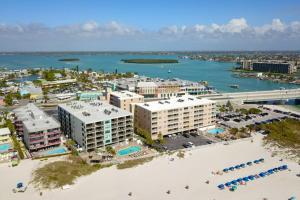 an aerial view of a resort with a beach and water at 103 - Sandy Shores in St Pete Beach