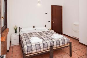 a bedroom with a bed with two towels on it at Residence San Raffaele 1 in Milan +34 photos