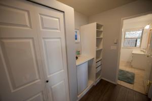 a white door in a room with a hallway at Shangri-La Oceanfront vacation home in Pender Island +32 photos