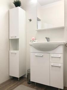 a white bathroom with a sink and a mirror at Apartament Active Moon in Lublin +29 photos