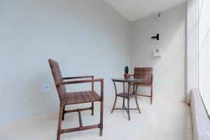 a dining room with two chairs and a table at Pousada Meireles in Fortaleza
