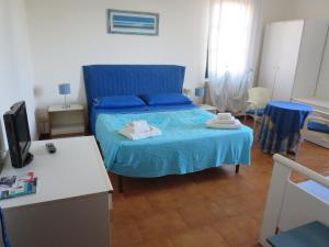 Ένα ή περισσότερα κρεβάτια σε δωμάτιο στο Belvedere Sul Mare