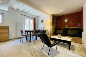 a living room with a table and chairs and a couch at Le Mathilde Cocoon in the heart of Les Halles in Tours