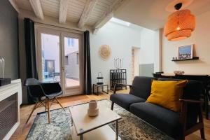 a living room with a couch and a table at The EDGARD Cocoon in the heart of Les Halles in Tours