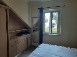 a bedroom with a bed and a window in it at Marasusa in Parghelia