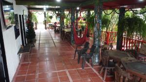 a restaurant with a patio with tables and chairs at Eco-Finca Los Buenos Aires in Cachipay