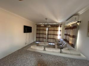 a living room with a couch and a tv at Telal Ain Sokhna Villa in Ain Sokhna