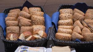 two baskets filled with different types of bread at Holiday Inn Express & Suites - Potsdam, an IHG Hotel in Potsdam
