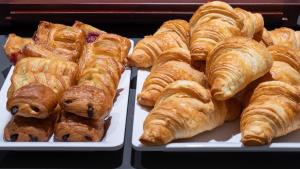 two trays of pastries and croissants on display at Holiday Inn Express & Suites - Potsdam, an IHG Hotel in Potsdam