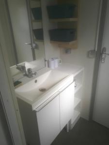 a bathroom with a white sink and a mirror at la dune blanche in Camiers +22 photos