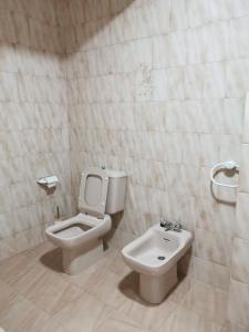 a bathroom with a toilet and a sink at Apartamento O Serrano in Finisterre +28 photos