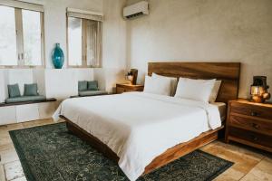 Cama ou camas em um quarto em Villa Nomada