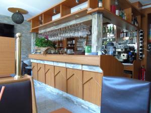 a bar with a wooden counter with glasses on it at Cáfe 168 in Vienna