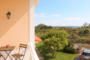 a view from the balcony of a house with a table and chairs at Quinta Amarela - B&B in Nazaré