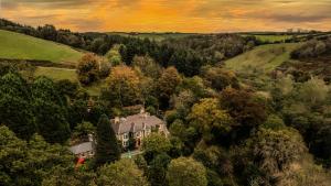 an aerial view of a house in the forest at Broomhill Estate Boutique Art Hotel in Barnstaple