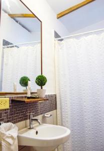 a bathroom with a sink and a mirror at Hotel Casa Pino, Tu Casa en Ataco in Concepción de Ataco +140 photos